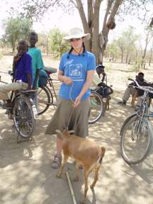 Mel with goat and bicycle donations